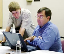 Shay Edwards, left, confers with Jim Seffrin, right at IR/INFO 2006.