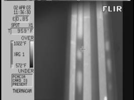 Thermal image shows hotspots caused by internal coke deposits. Image taken through opaque flame.