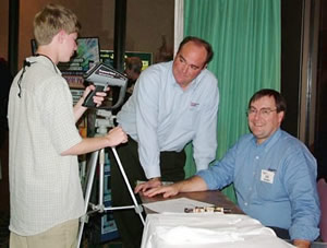 Shay Edwards, left, confers with Chris Seffrin, center, and Jim Seffrin, right at IR/INFO 2006.